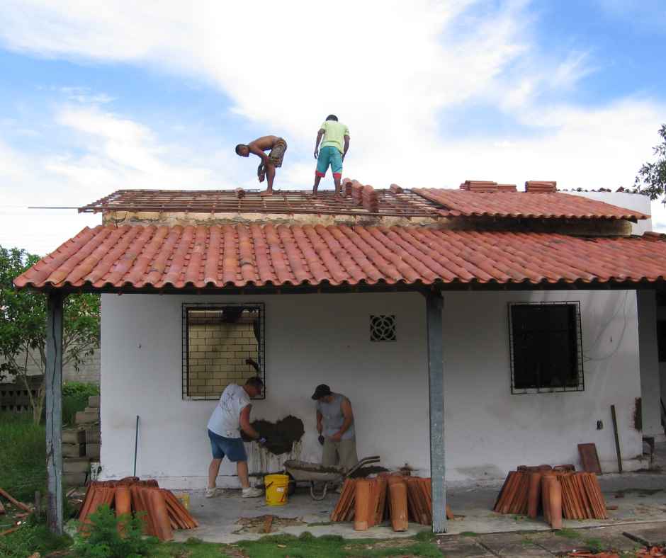 Med working on building/roofing