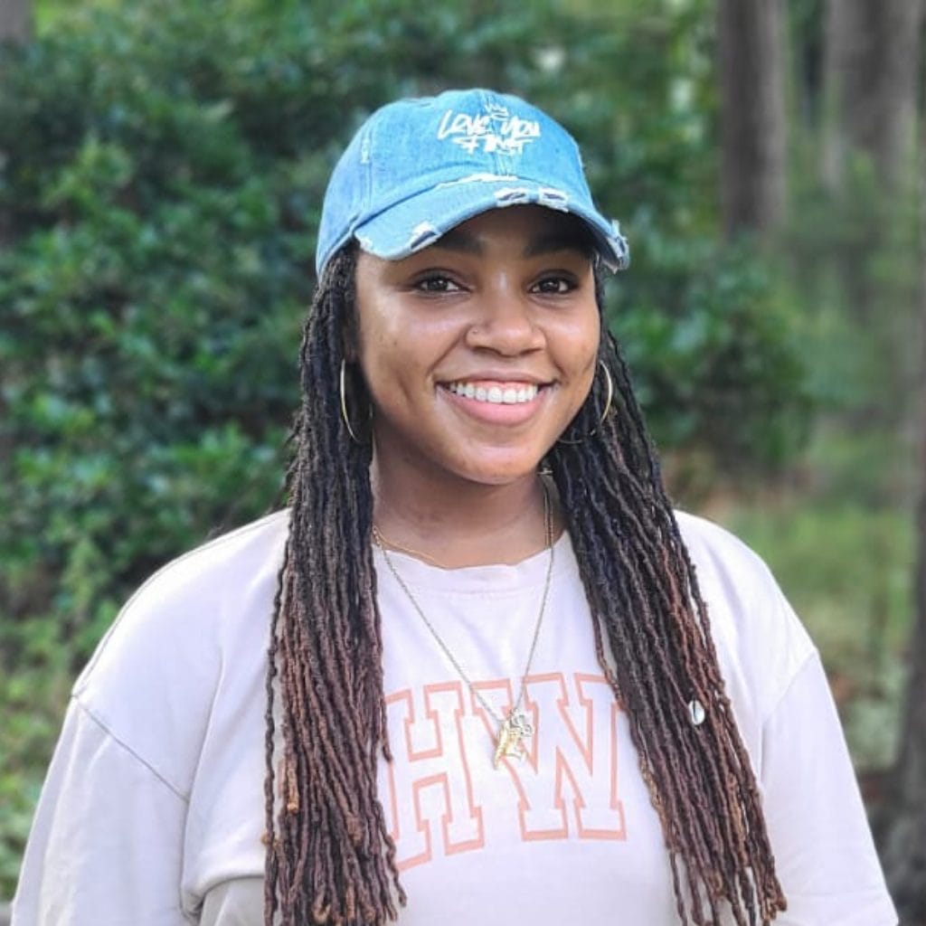 Krystal in front of a bush